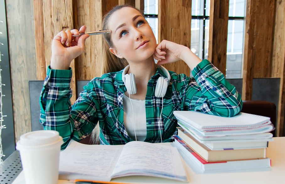 student with books on table